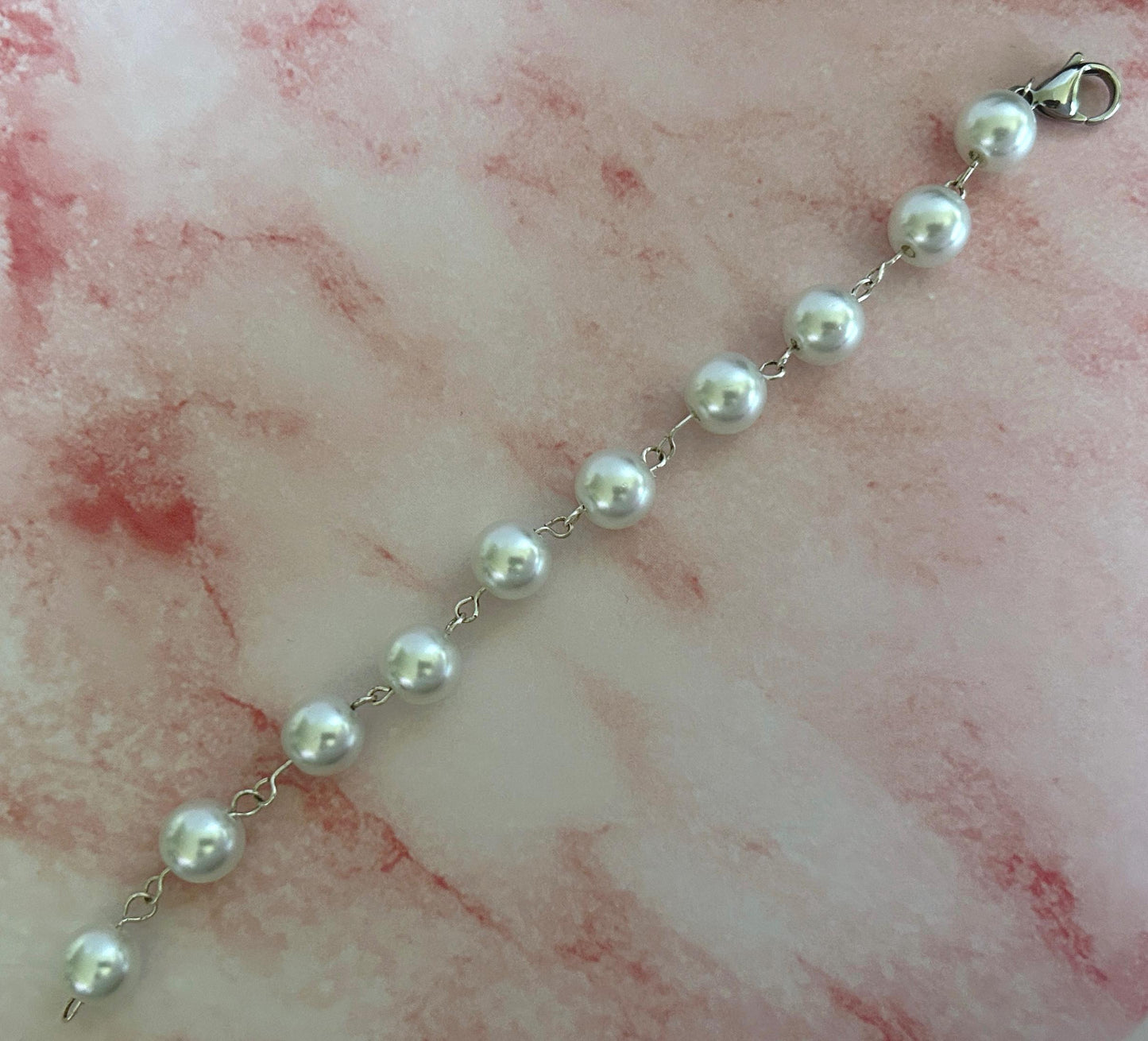 Pearl link bracelet unclasped and laid out.