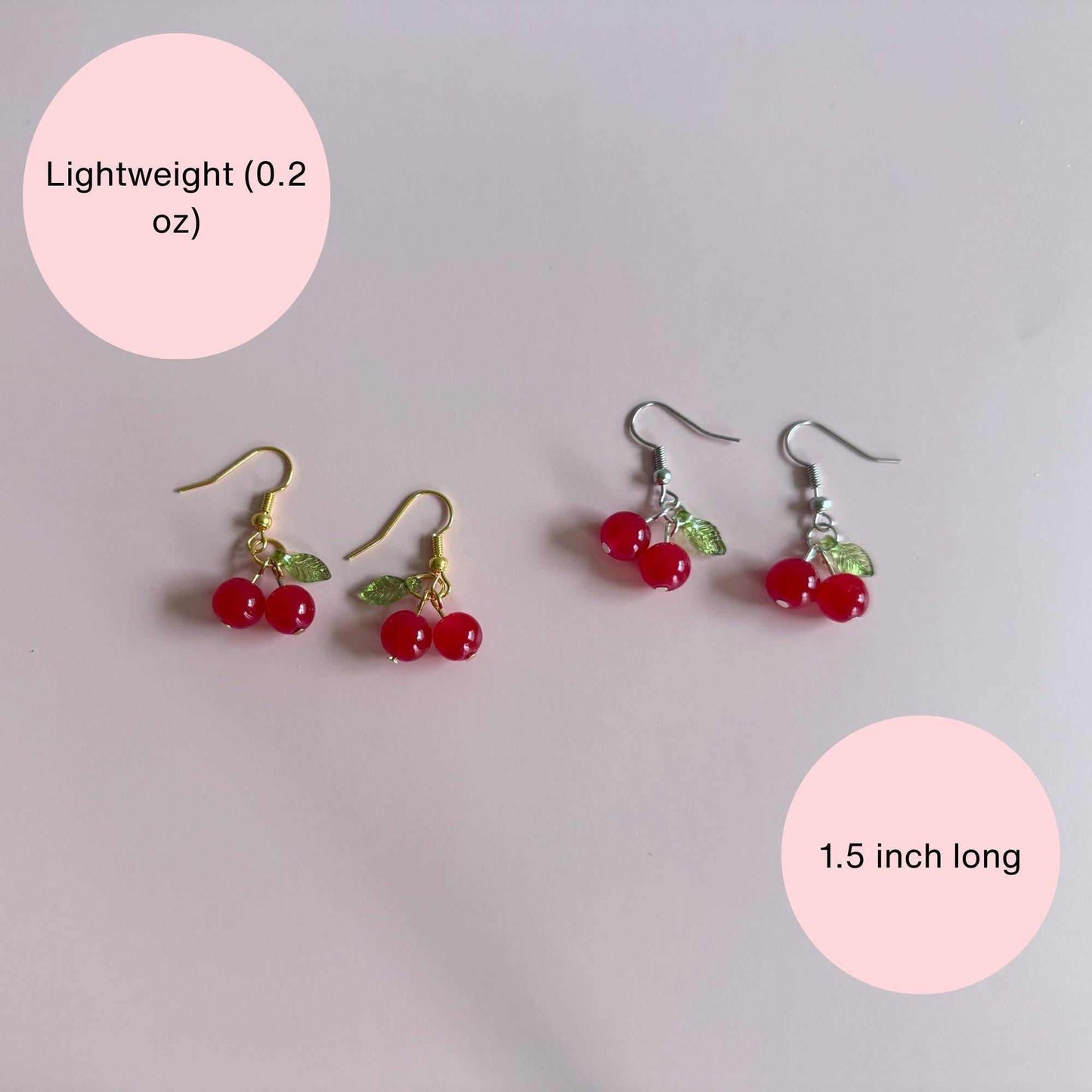 Red cherry earrings on a stand with text explaining that the earrings are lightweight and dainty
